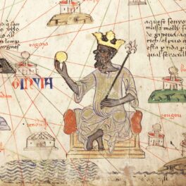 Desen cu Mansa Musa, cel mai bogat om din istorie, și o hartă cu ce a reușit să facă de-a lungul timpului. Poartă o coroană de aur