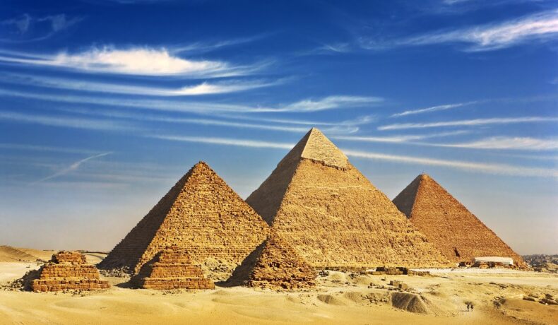 Celebrele piramide din Giza, construite în deșert, cu cerul albastru pe fundal. Ultima piramidă regală construită în Rgipt avea mormântul construit în spatele ei