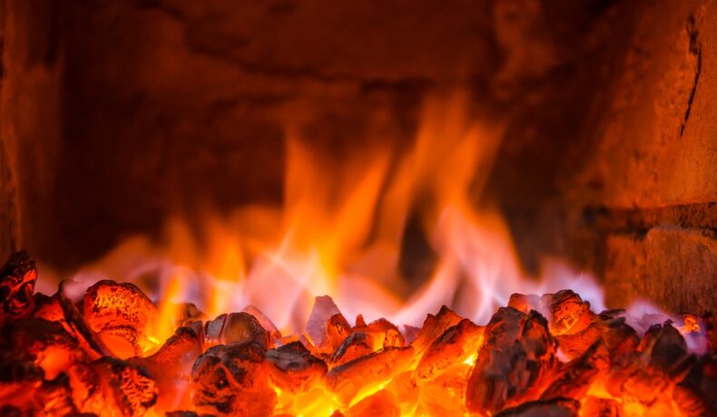 Foc de cărbuni într-un grătar din piatră, în nuanțe de roșu și portocaliu. Focul de 6.000 de ani din Australia e un foc de strat de cărbune