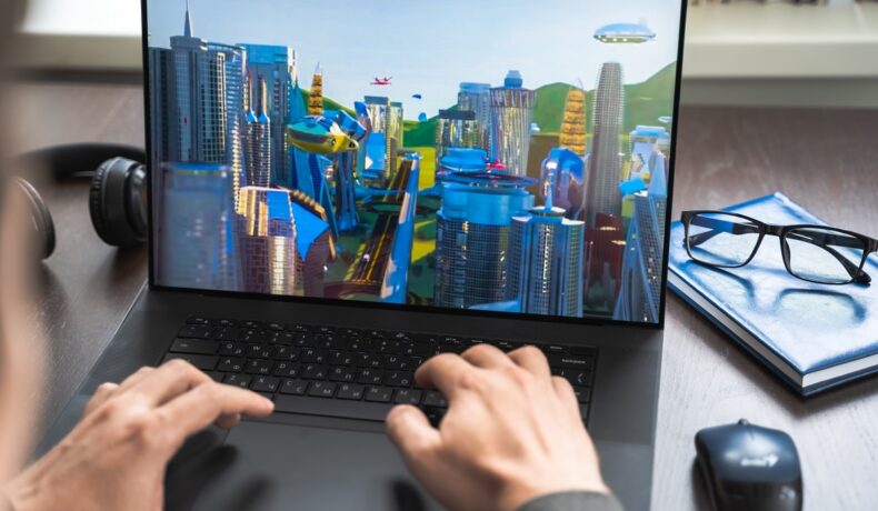 Utilizator care se joacă un joc cu clădiri SF pe un laptop. Vânzările proprietăților din metavers au crescut semnificativ