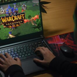 Jucător care e la calculator și se joacă Warcraft, precursrul World of Warcraft, ce va permite acum jucătorilor să joace împreună