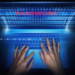 Hacker care încearcă să acceseze o parolă, cu laptop albastru, pe fundal negru. De ziua mondială a parolei 2022, trebuie să îți verifici parolele