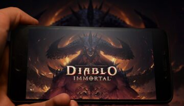 Utilizator care ține în mână un telefon cu imagine Diablo pe ecran. recent, pe Internet au apărut primele imagini din Diablo 4