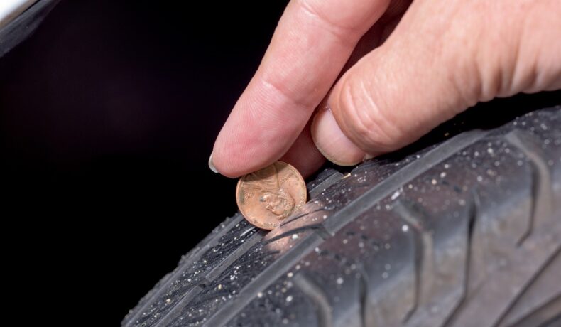 Monedă de un penny introdusă în banda de rulare a anvelopei, care e testul de 1 secundă recomandat de experți